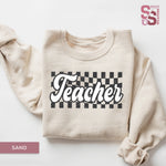 a sweatshirt with the word teacher printed on it