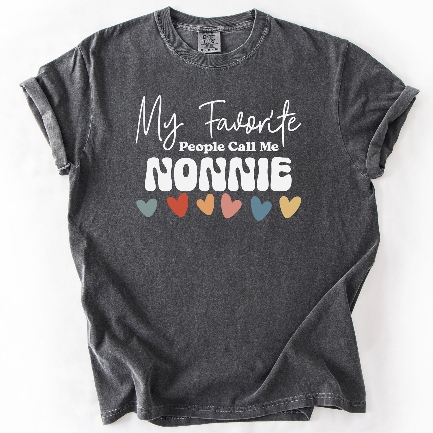 Charcoal gray t-shirt with My Favorite People Call Me NONNIE text and colorful heart accents.