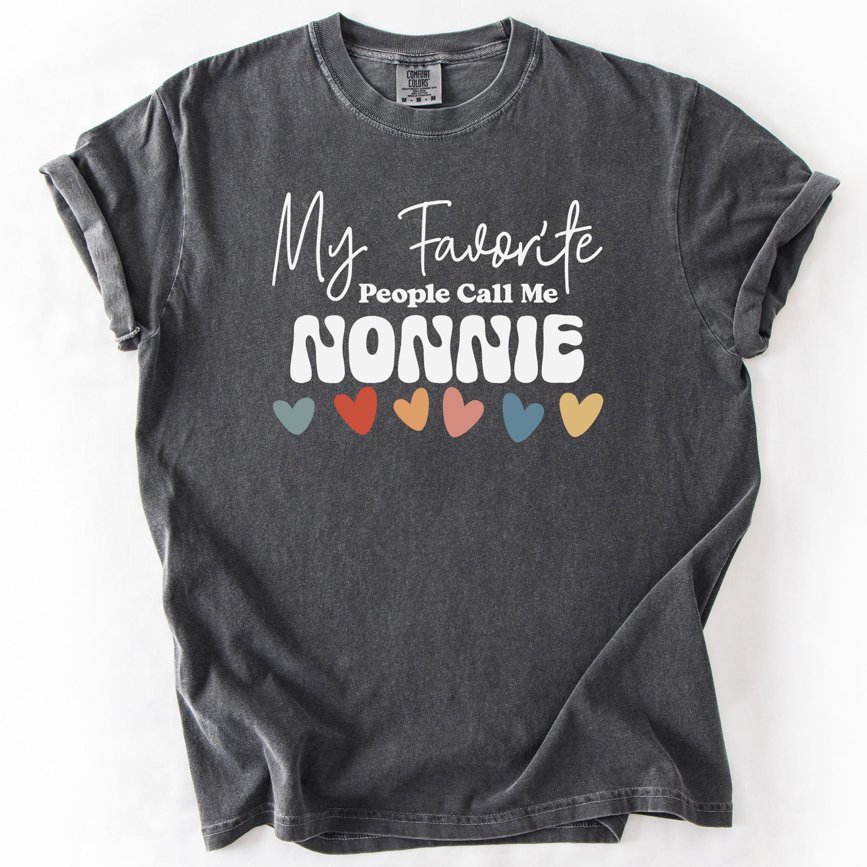 Charcoal gray t-shirt with My Favorite People Call Me NONNIE text and colorful heart accents.