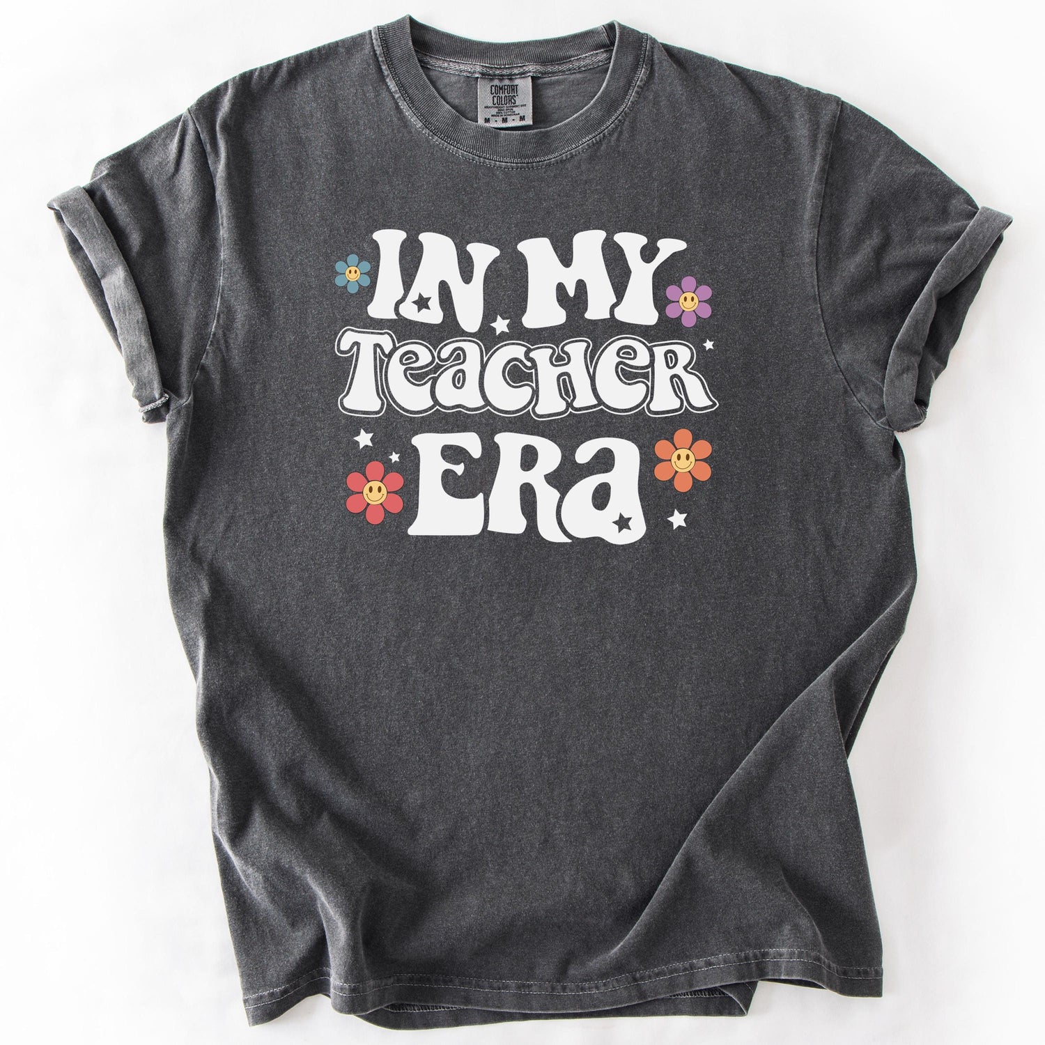 Gray graphic t-shirt with IN MY TEACHER ERA text and colorful floral accents.