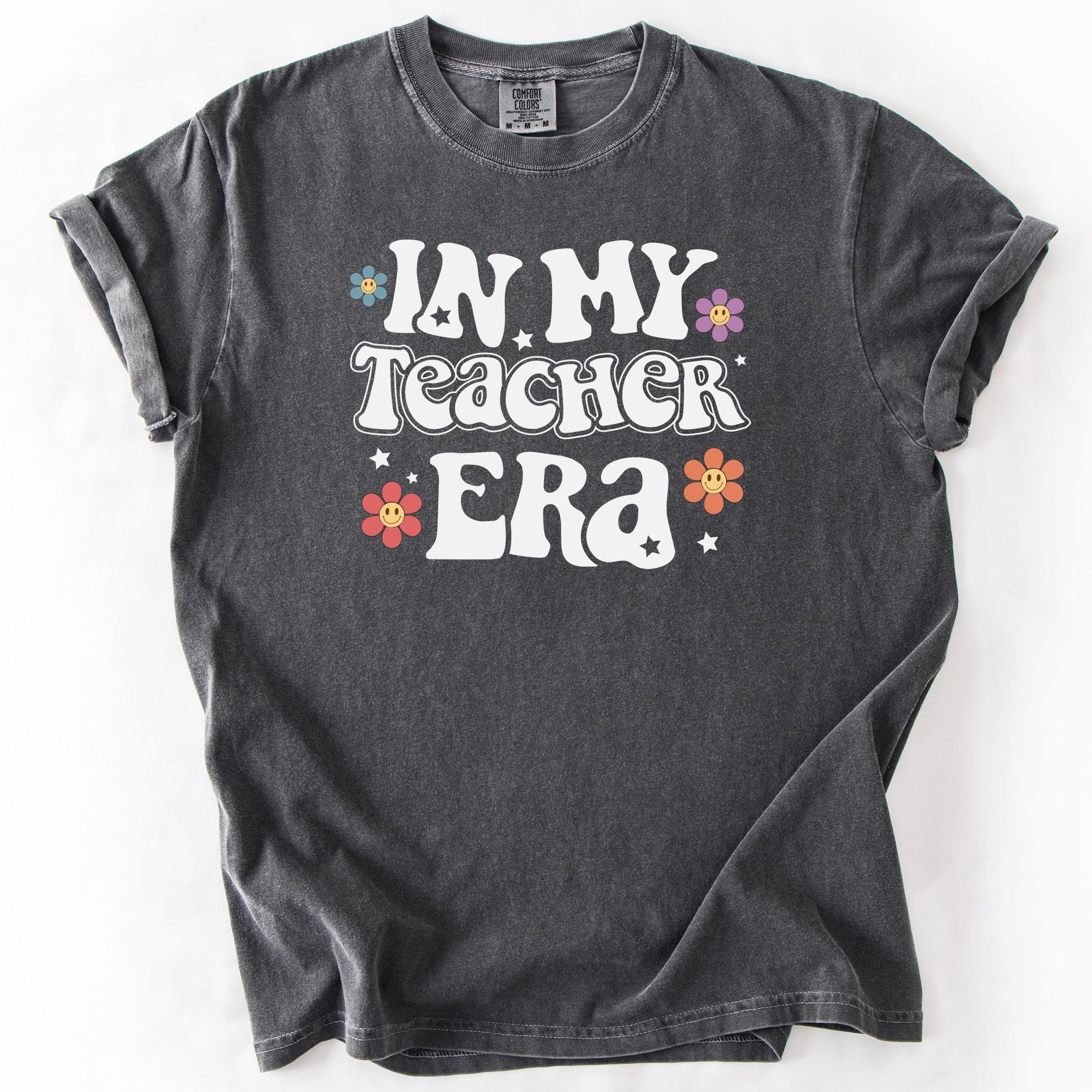 Gray graphic t-shirt with IN MY TEACHER ERA text and colorful floral accents.