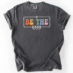 Charcoal gray, short-sleeve graphic t-shirt with BE THE GOOD text.