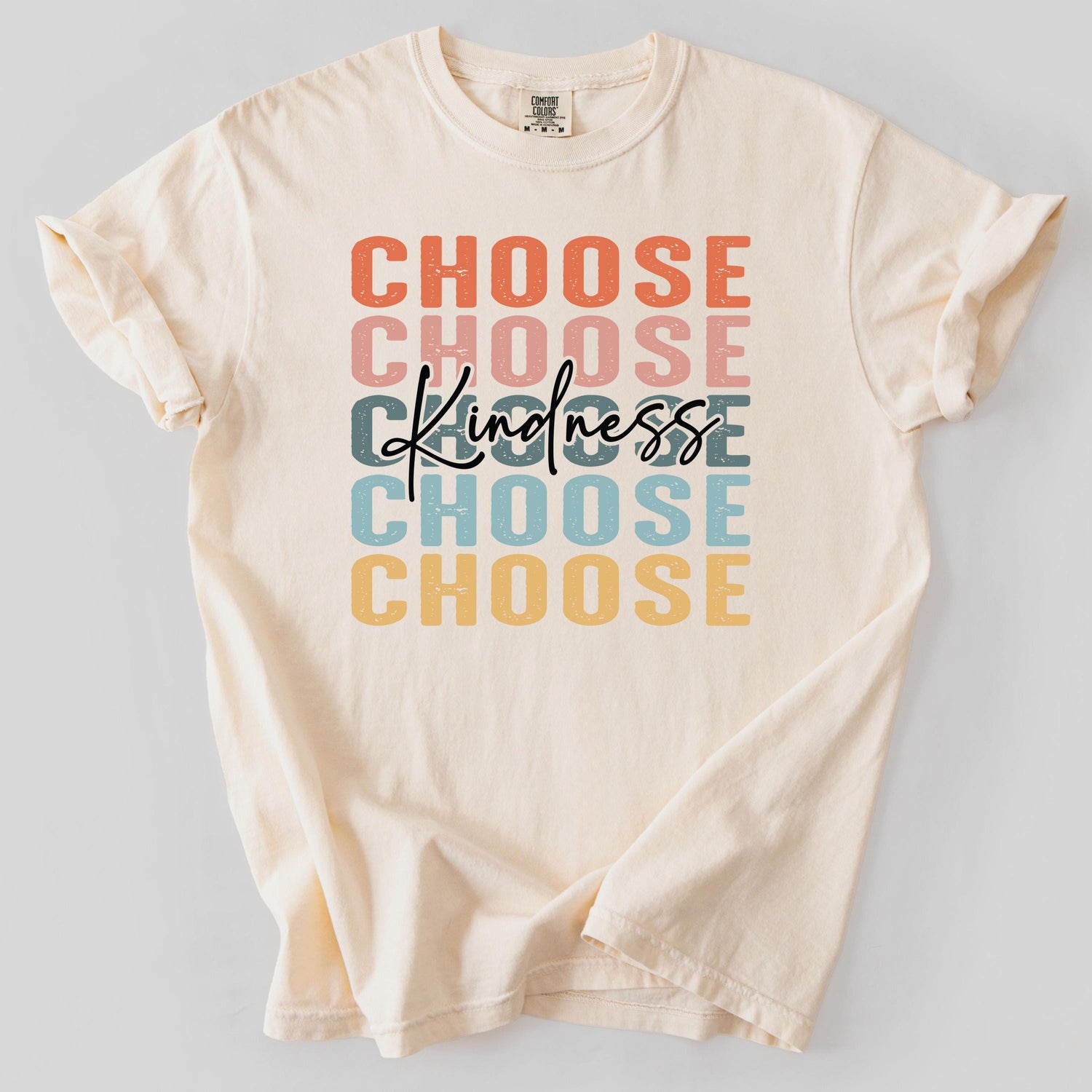 Cream-colored t-shirt with Choose Kindness graphic text design.