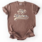 Brown, graphic t-shirt with Ag Teacher text in retro style.