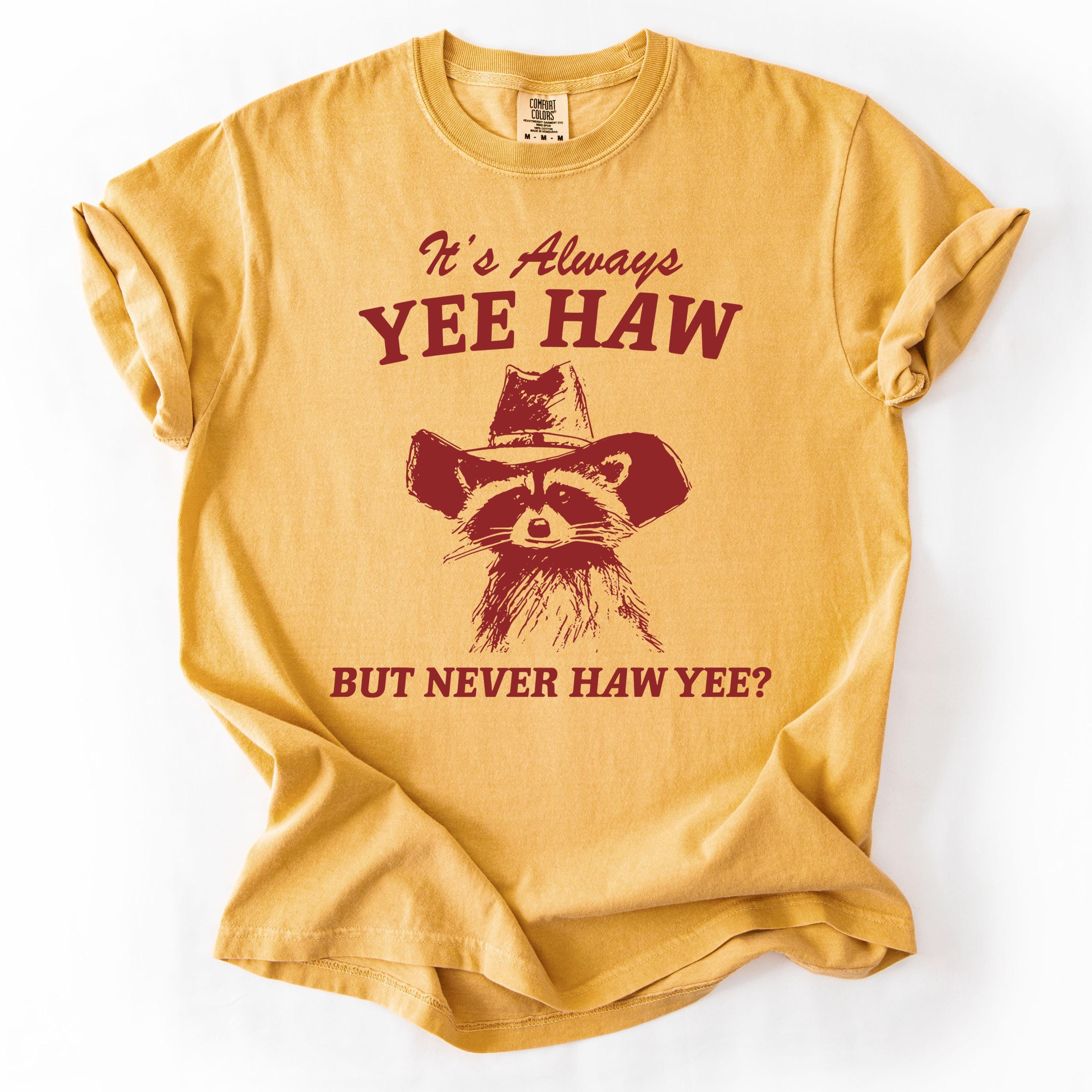 Yellow graphic t-shirt with raccoon design and text.
