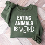 Olive green sweatshirt with bold white text saying EATING ANIMALS IS WEIRD.