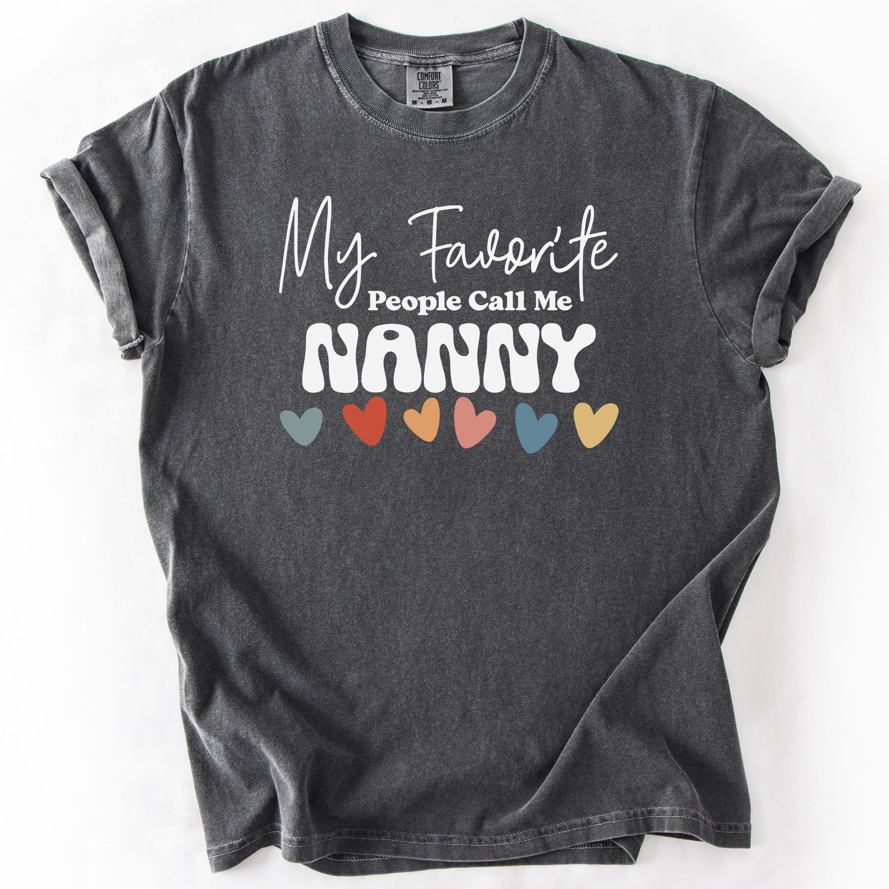 Charcoal gray, short-sleeve t-shirt with My Favorite People Call Me Nanny text and colorful hearts design.