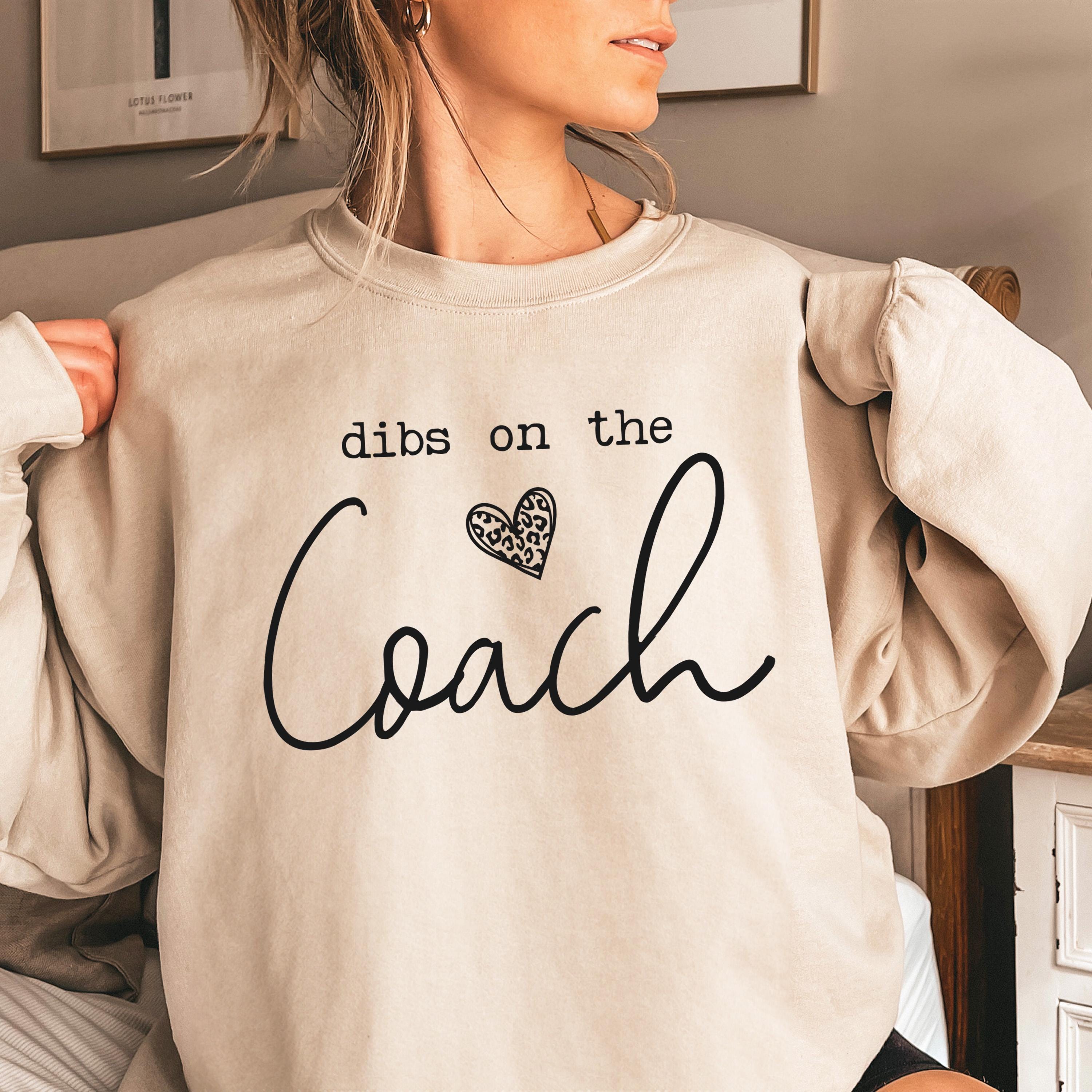 Cream oversized sweatshirt with dibs on the Coach graphic.
