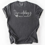 Charcoal gray, short-sleeve t-shirt with Dermatology Medical Assistant graphic. Personalize Print