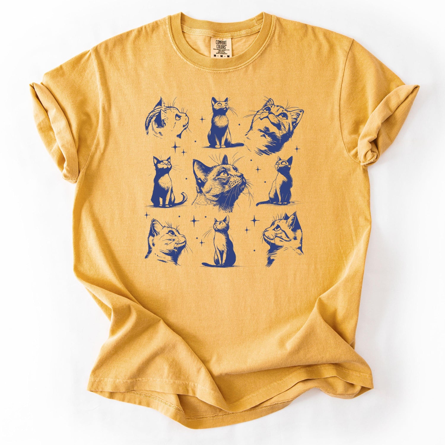 Yellow graphic t-shirt featuring various cat illustrations.