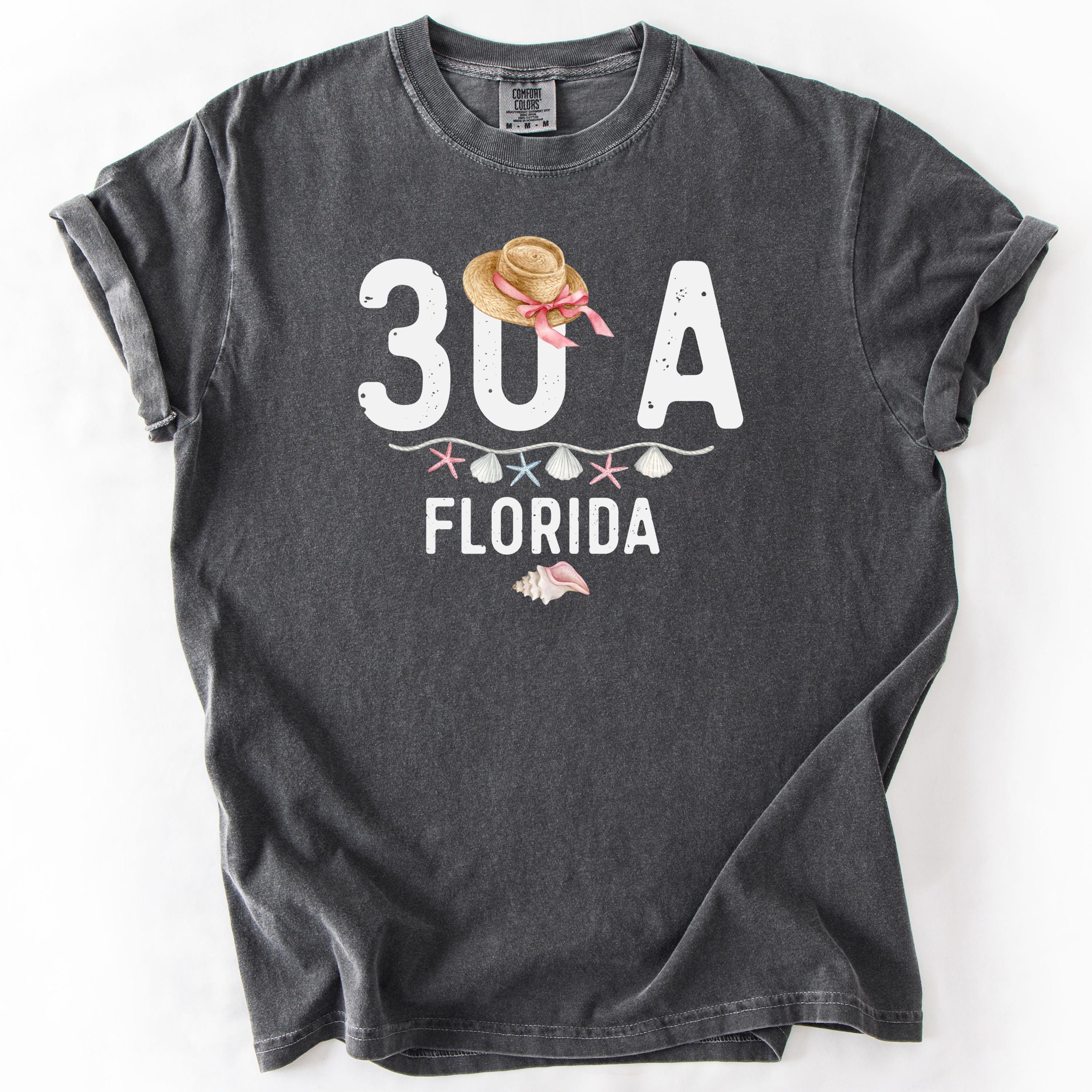 Dark gray t-shirt with 30A FLORIDA graphic and beach elements.